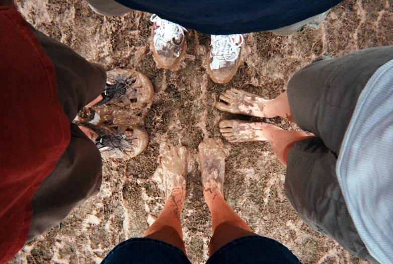 two people standing in the middle of a floor with their legs crossed