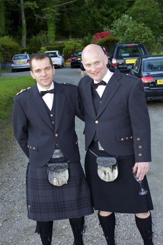 two men in kilts are posing for a picture