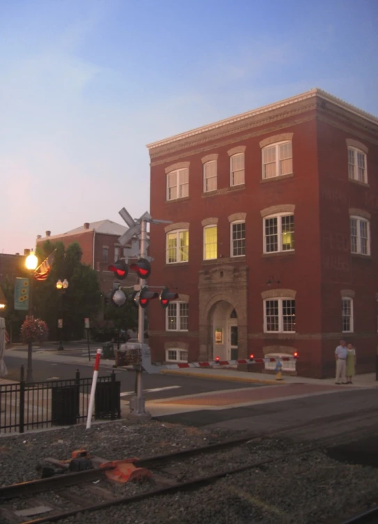 a building at sunset with several lights above the street