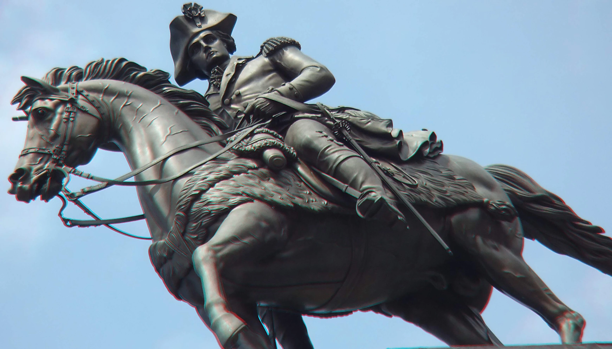 a statue of a person riding on top of a horse