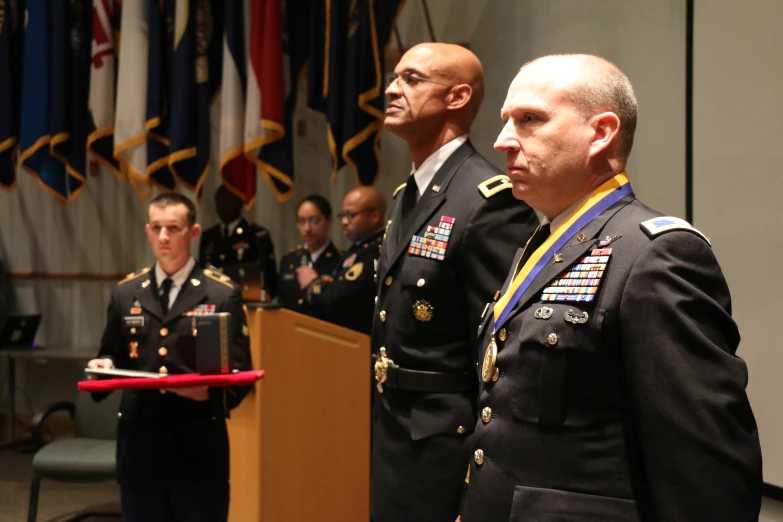 a man standing next to another man wearing a medal