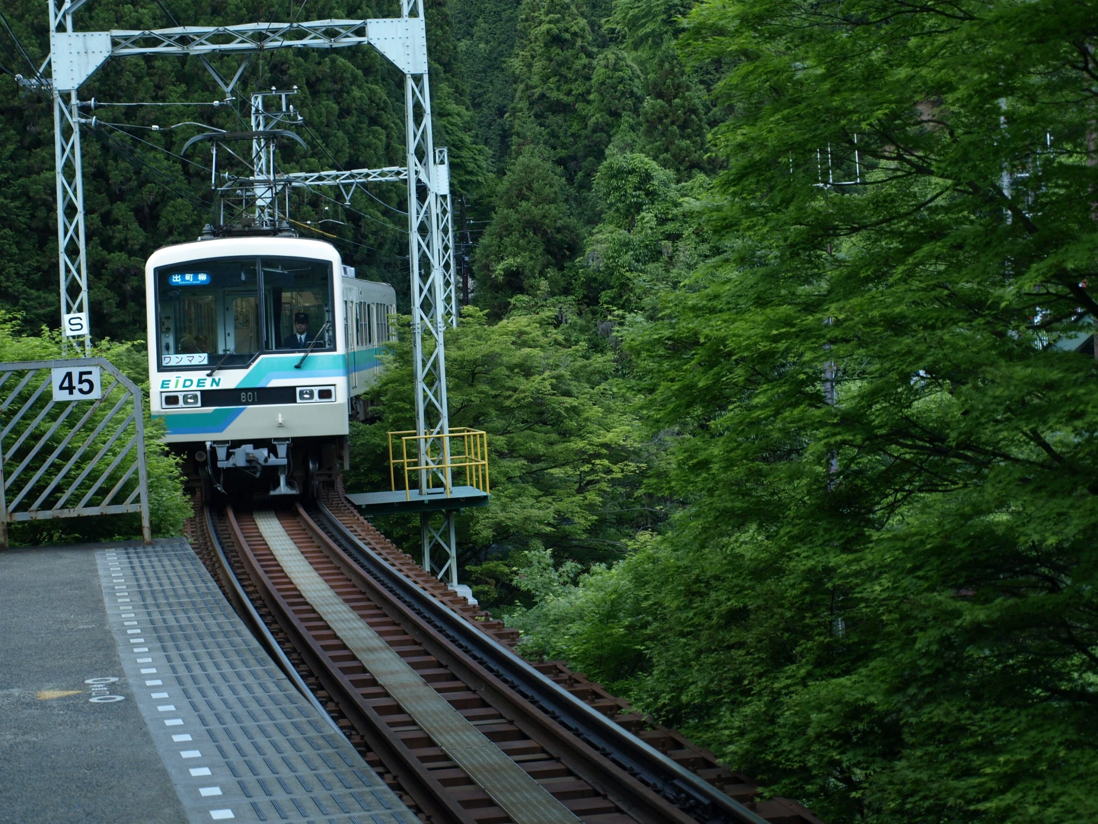 the blue and white train is making its way down the tracks