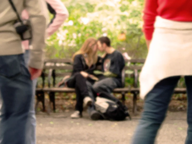 a group of people are standing near one another and sitting down