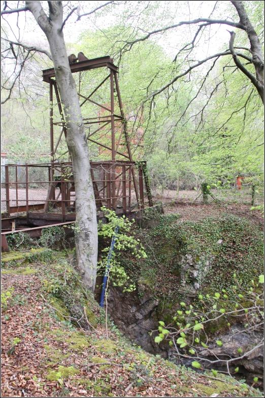 a metal bridge going over a small waterfall