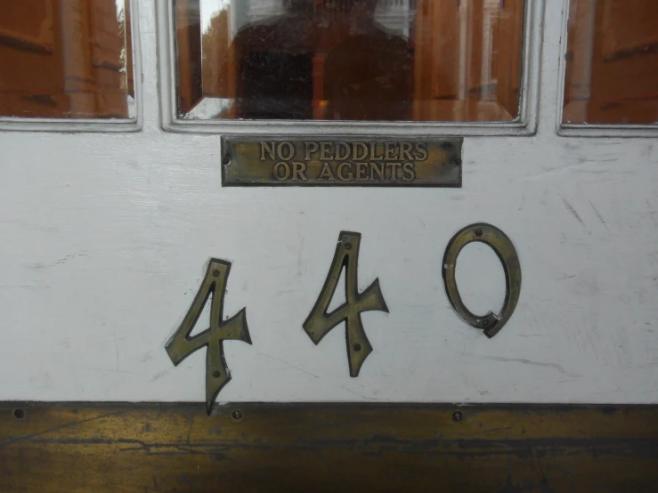 a number sign on a door by a window