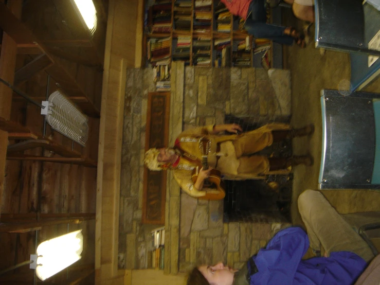 a large room filled with two people and wooden benches