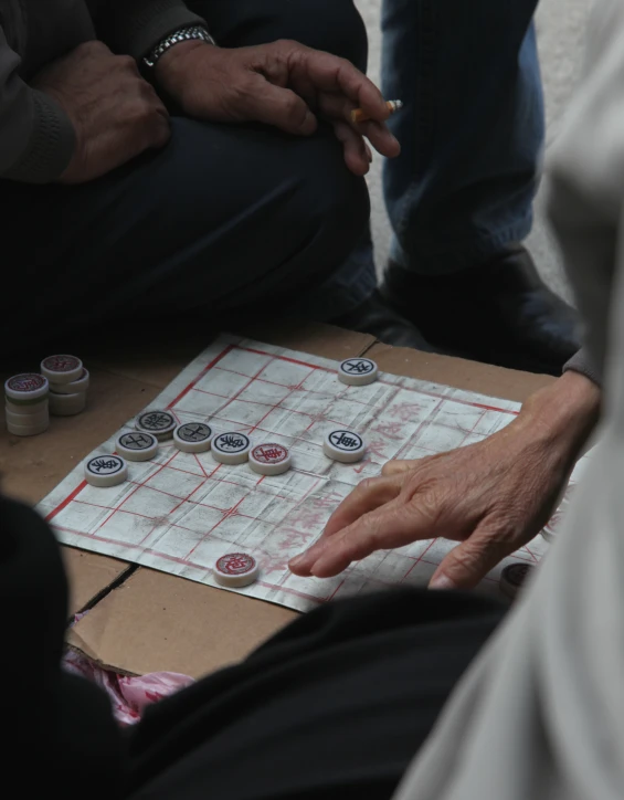 a person sitting at a table while playing a game