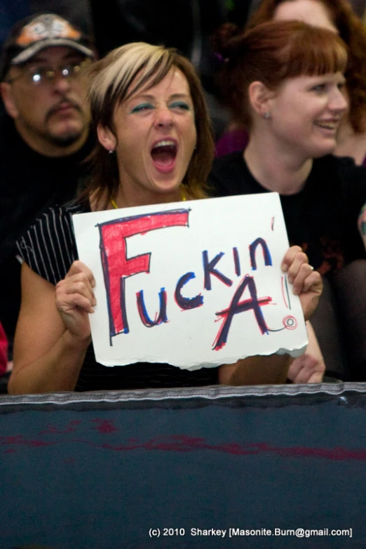 a young woman holds a sign saying ing a