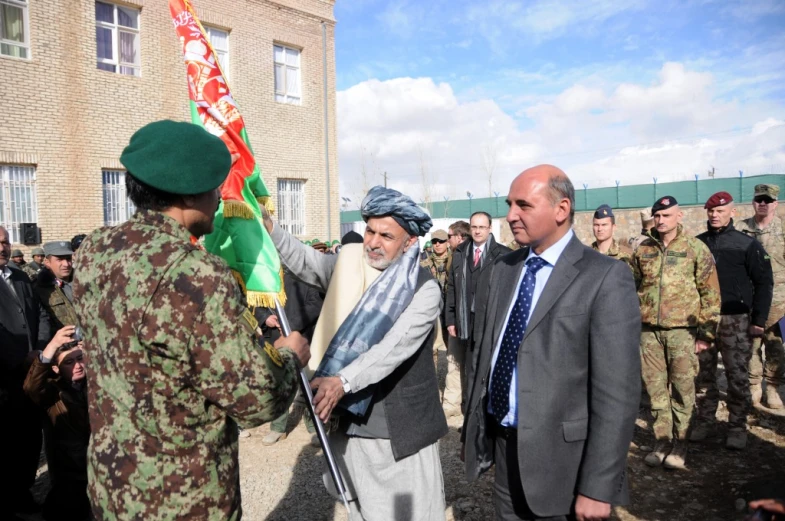 a group of soldiers and some men dressed in suits