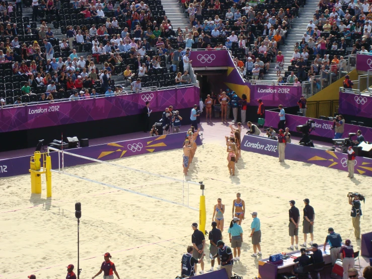 a volleyball court in a stadium with people watching