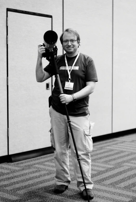 black and white pograph of man holding up camera