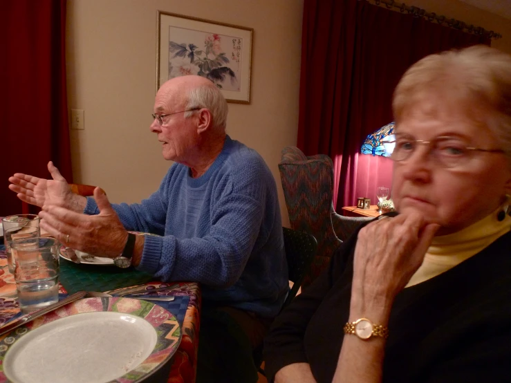 a couple of people sitting at a table eating food