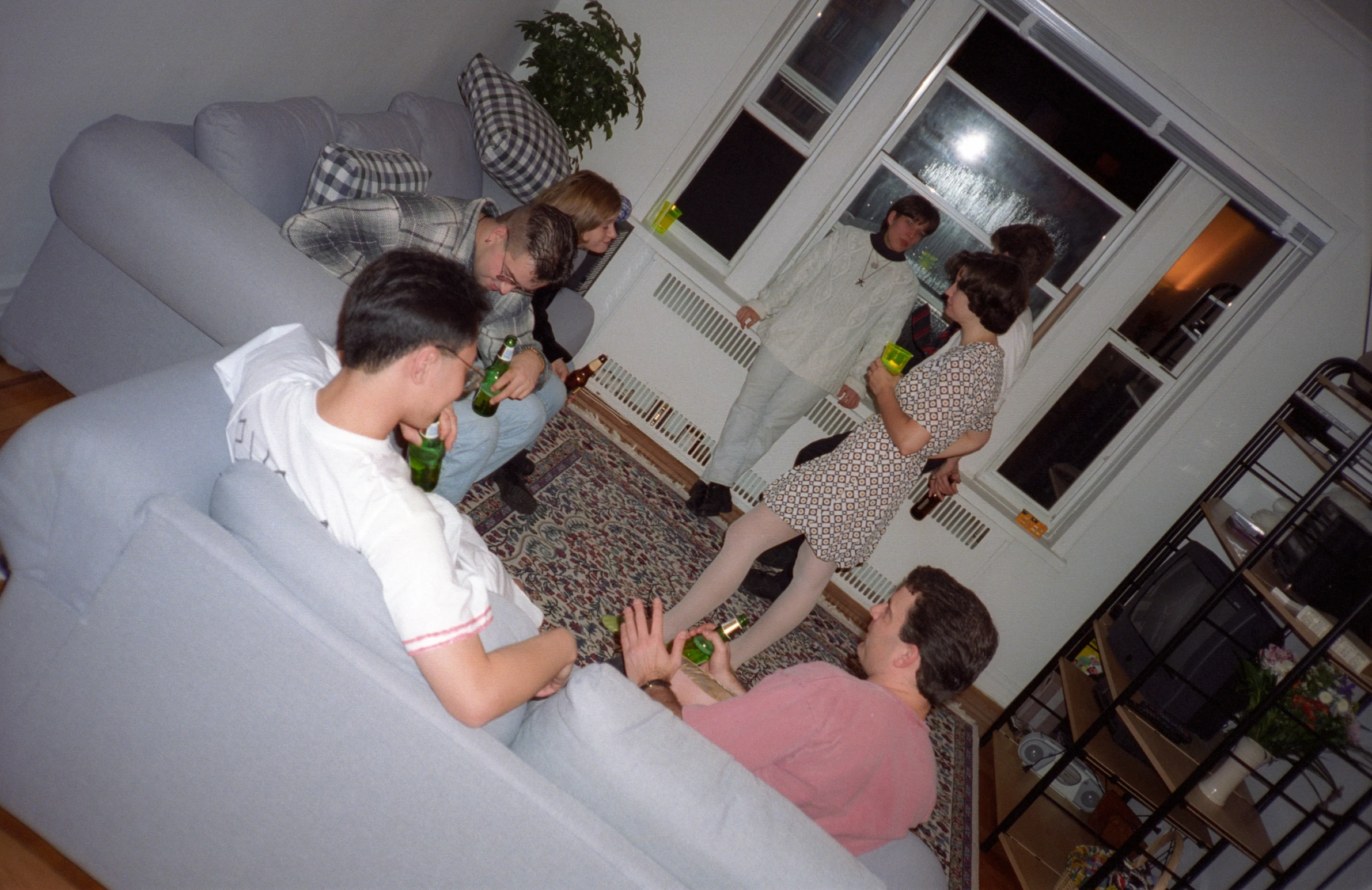 a group of people sitting around talking and drinking