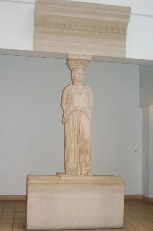 an ancient statue in the middle of a museum