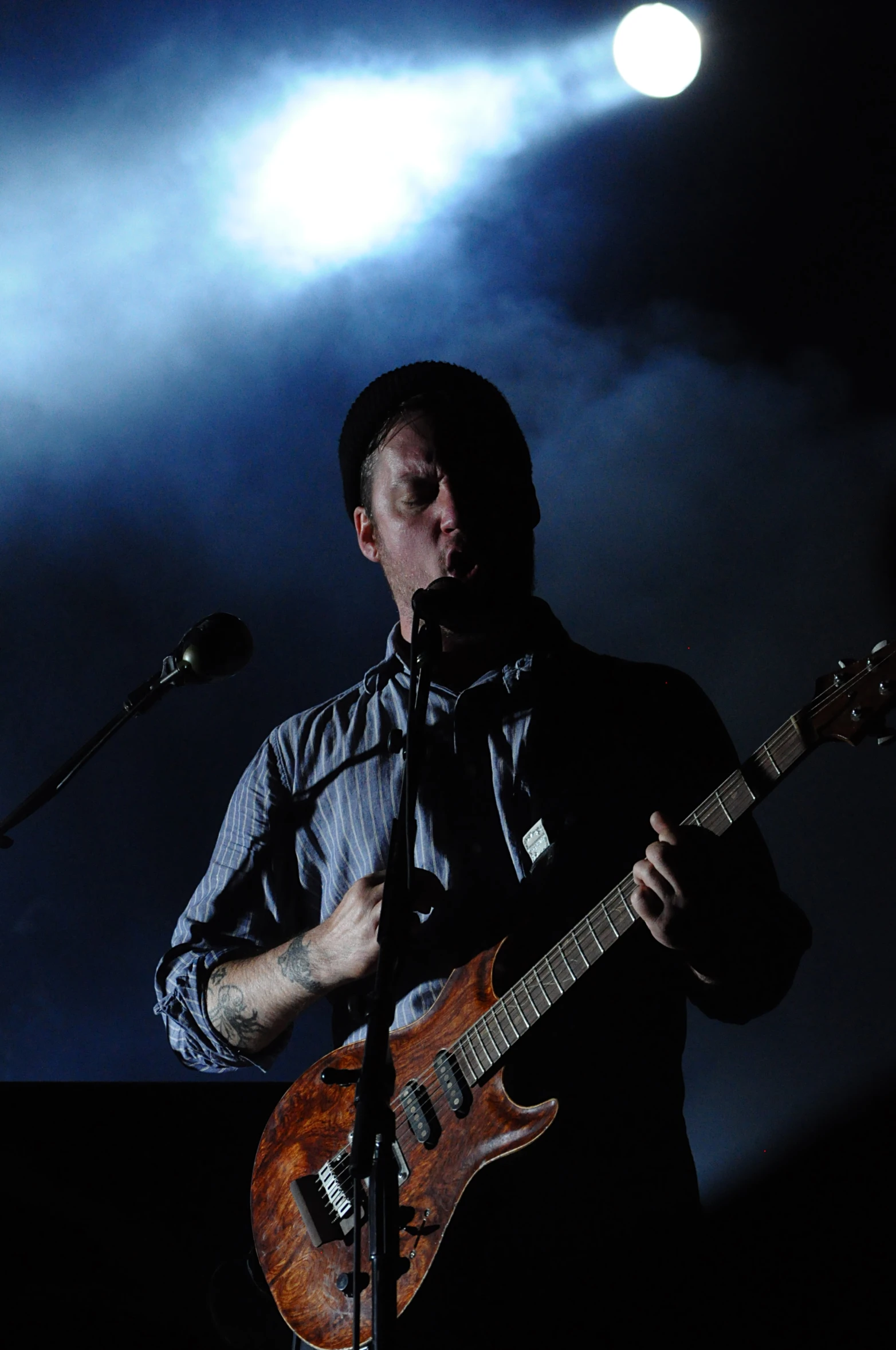 a man is playing guitar at a concert