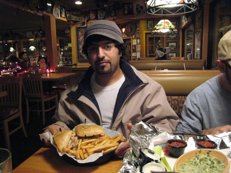 two men at a table eating some food