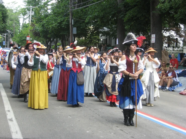 a parade is coming down the street in costume