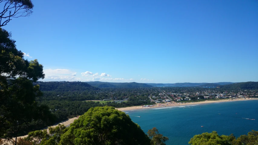 the view from above the mountain shows a beach and blue waters
