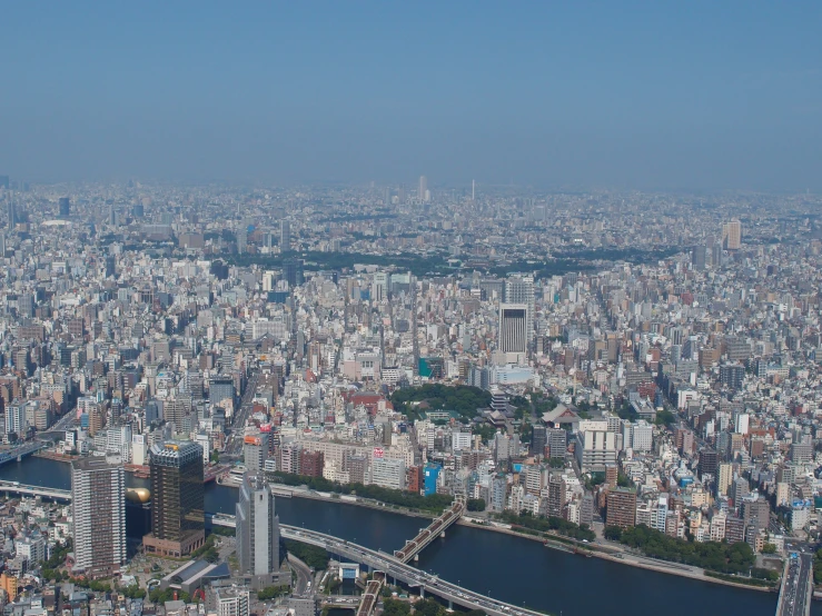 a city view from the sky of a river and bridge