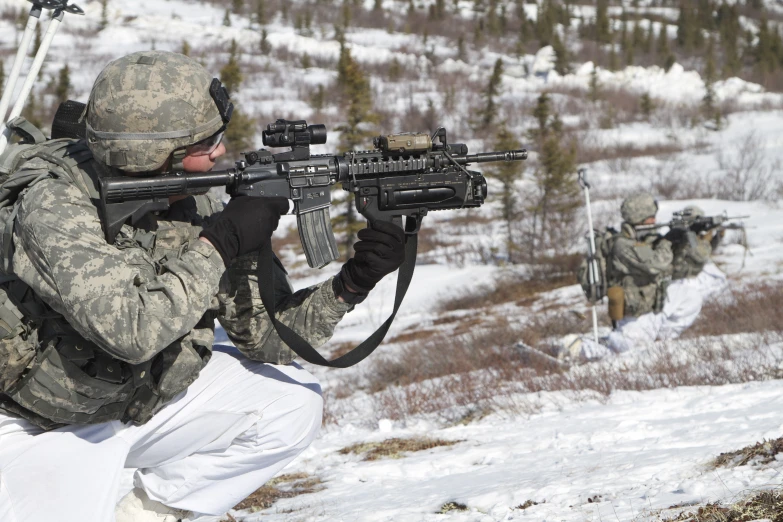 soldiers from the military take position in the snow