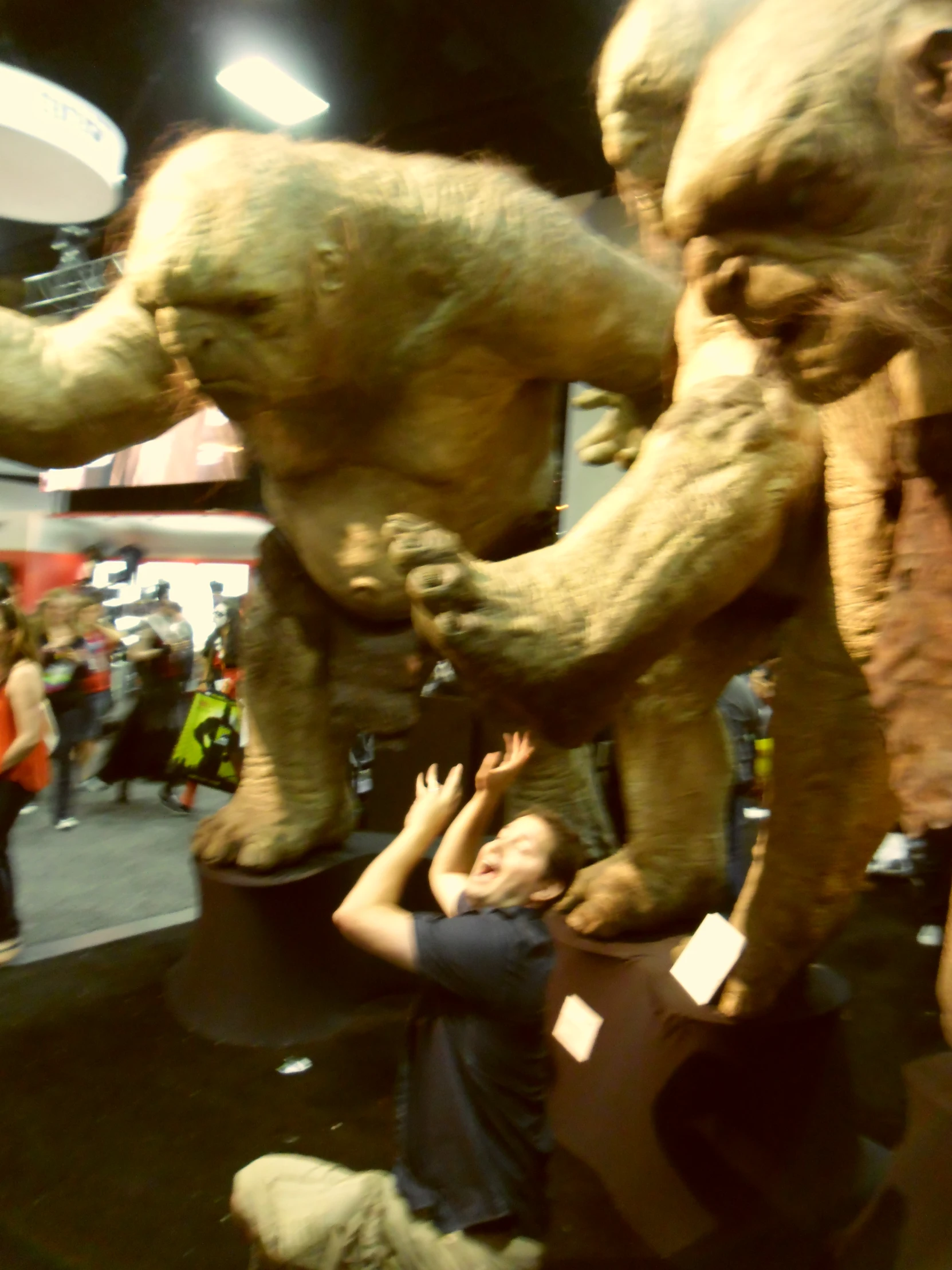 two men work on a giant statue in a museum