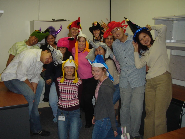 some people wearing funny hats and posing for a picture