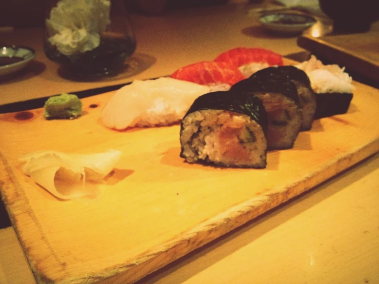 assorted sushi on a  board in a restaurant