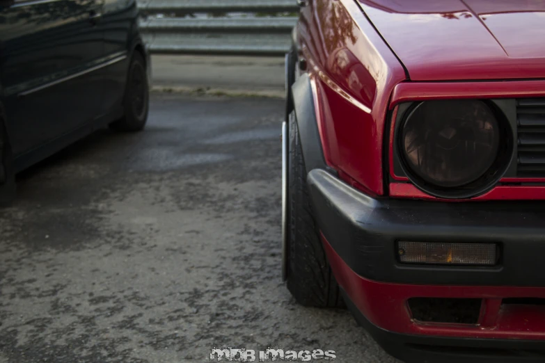 the front end of two cars parked next to each other