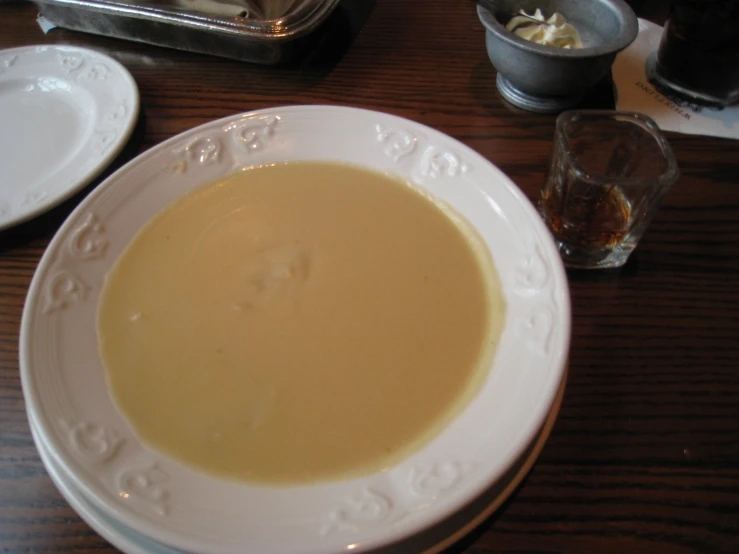 a bowl of soup on top of a white plate