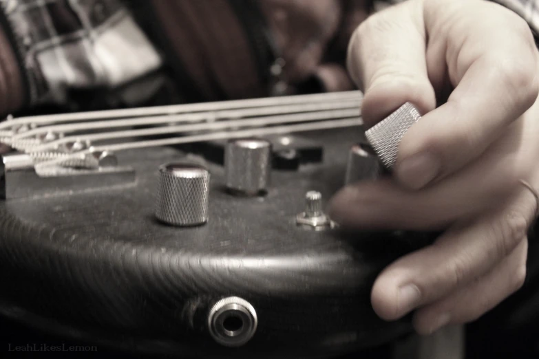 black and white pograph of a person holding on to guitar