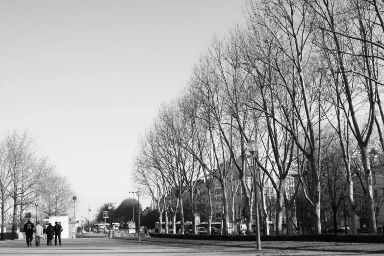 black and white pograph of a street with people walking around