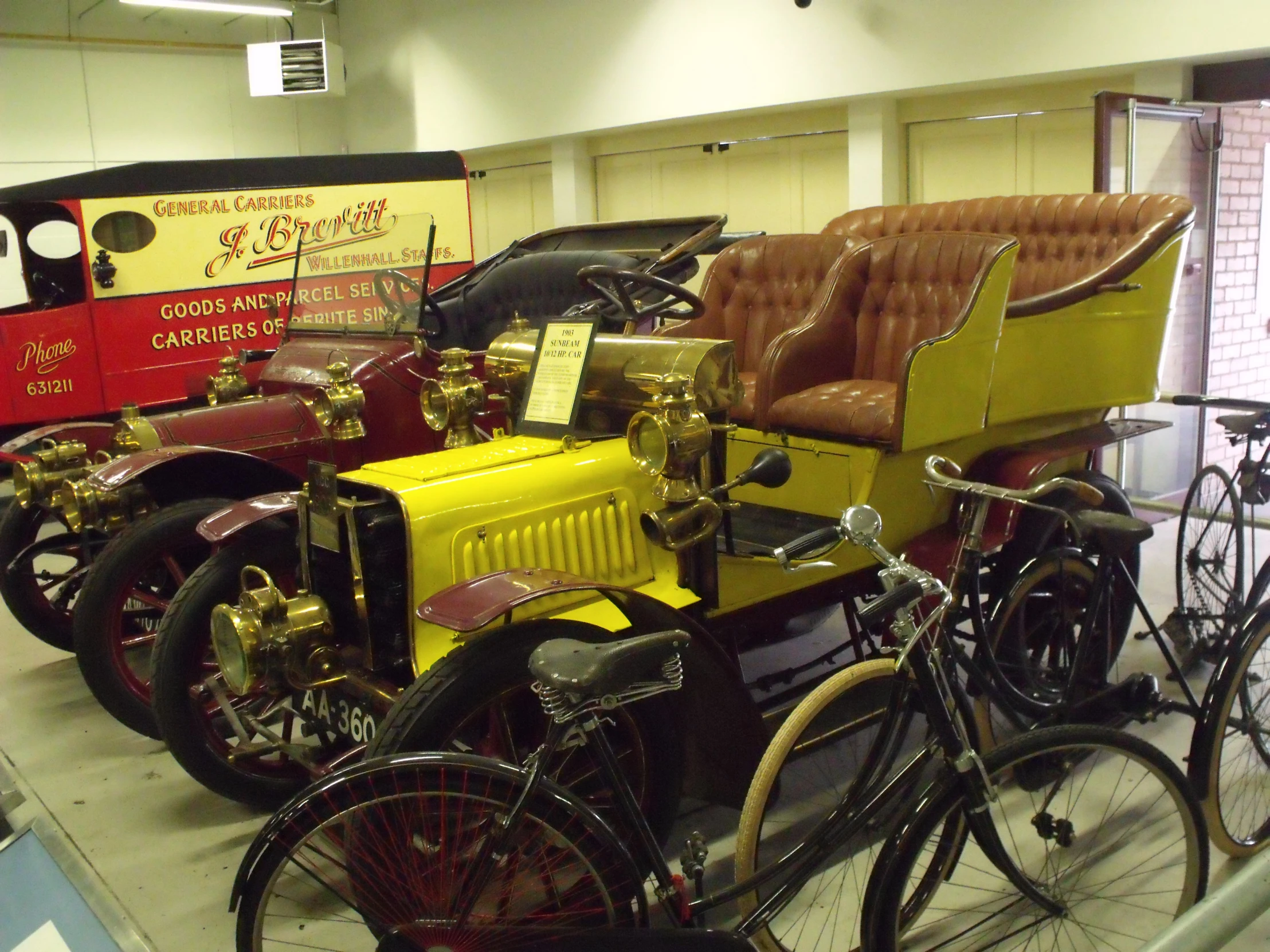 a yellow car and some bicycles are sitting together