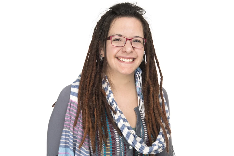 a women wearing glasses and a scarf poses for a picture