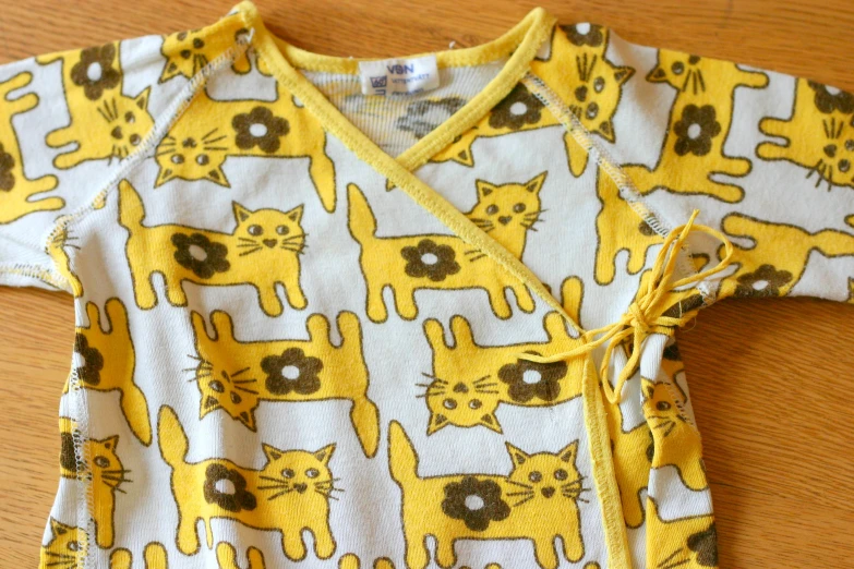 this is a shirt with yellow cat designs