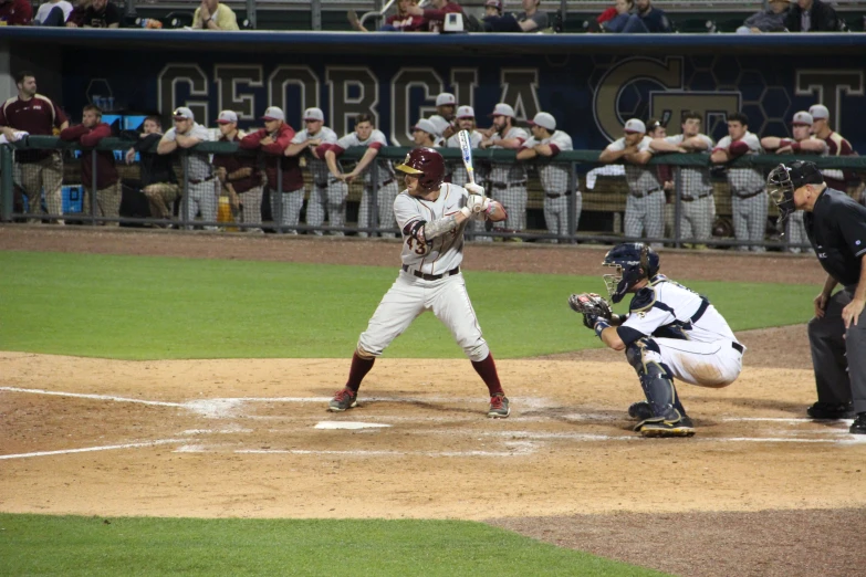 a baseball player at home plate with the bat raised