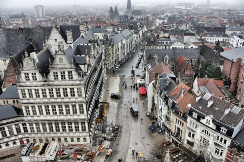 an overhead view of several old buildings, with many people walking around