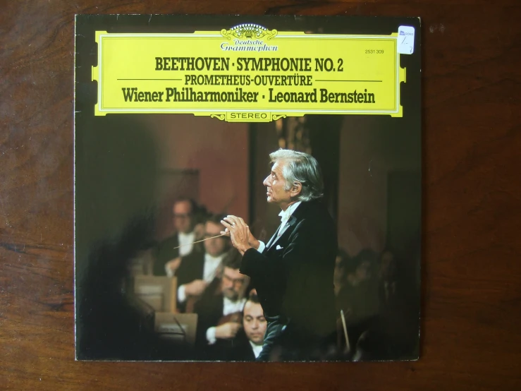 a cd with a conductor standing in front of a group