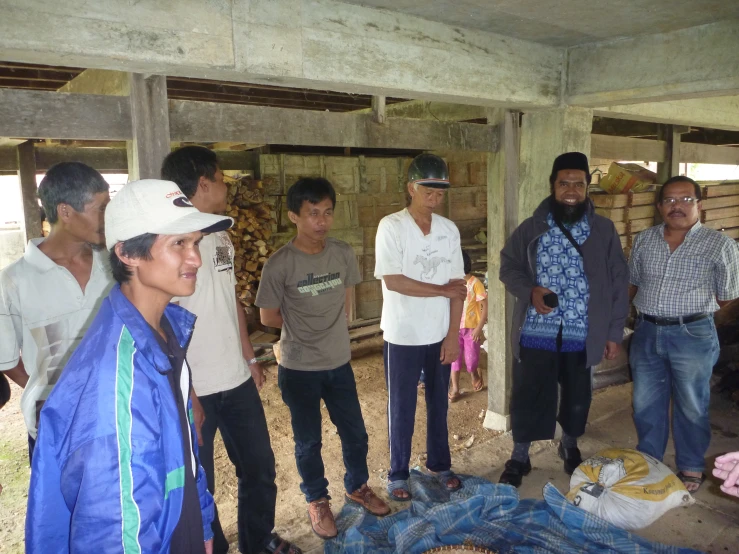 a group of people standing around each other in a room