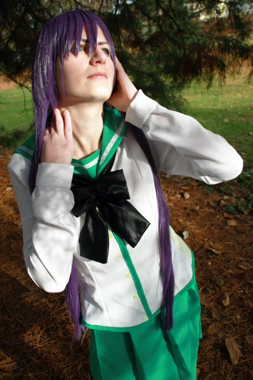 girl in the woods wearing green and white outfit and black ribbon