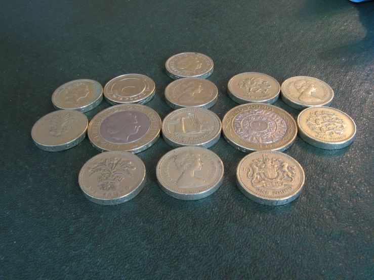 several silver coins are on a table and on the floor