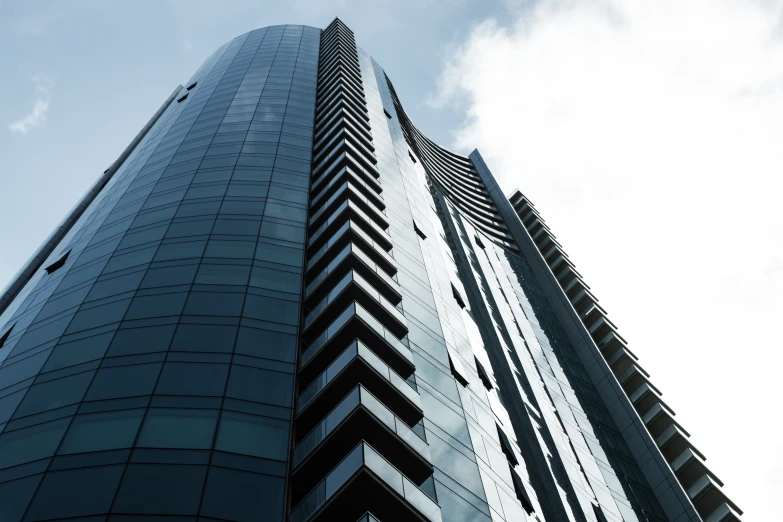 an up close s of a very tall glassy building