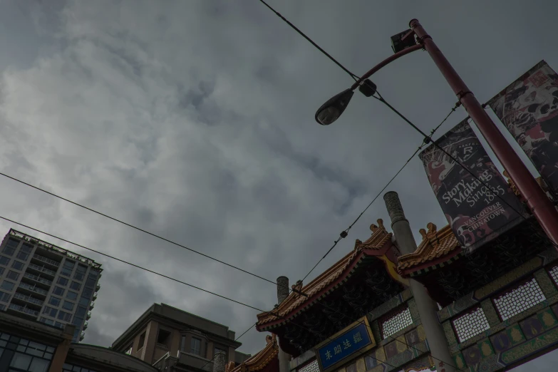 a large pole holding a street lamp near some buildings