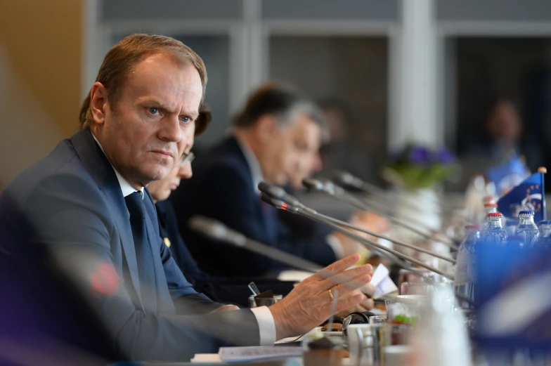 two men sitting at a table during a meeting