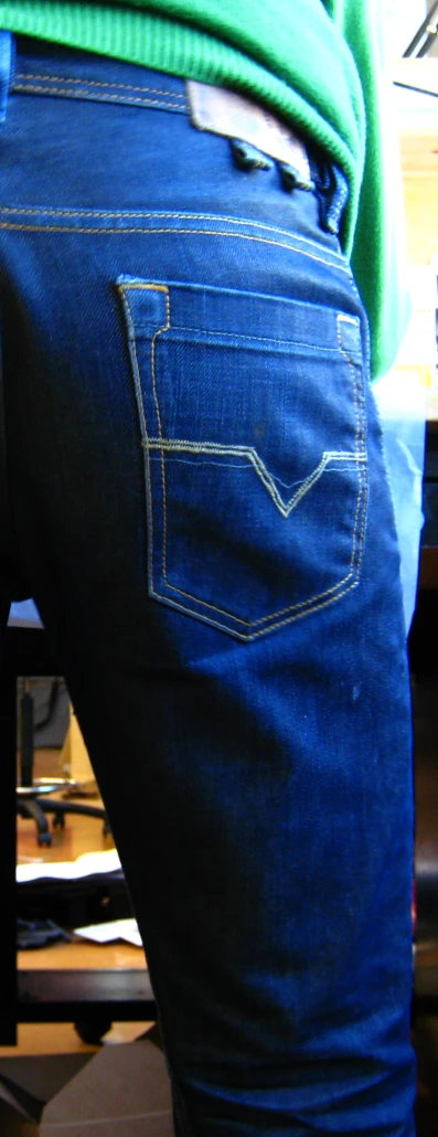 someones jeans with their back turned showing the bottom pocket