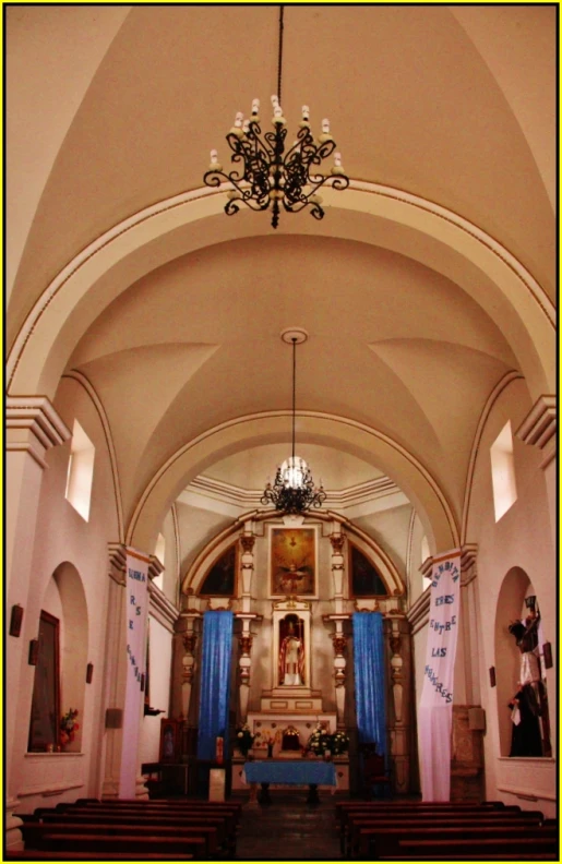 a church with two columns and walls that has some writing on the inside