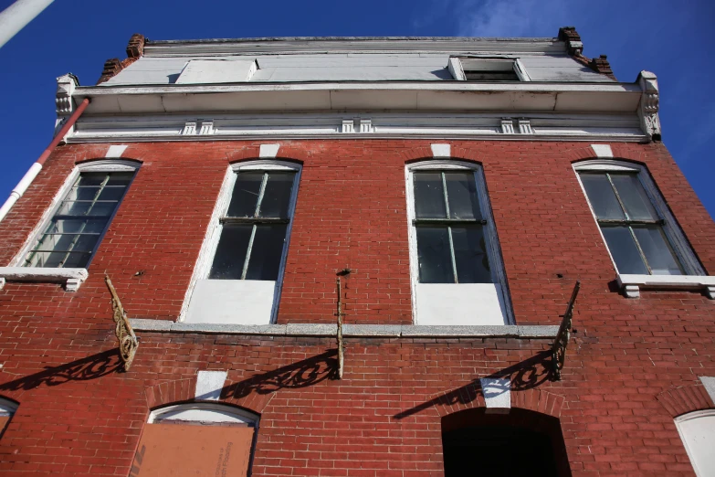 an old red brick building with some windows on top