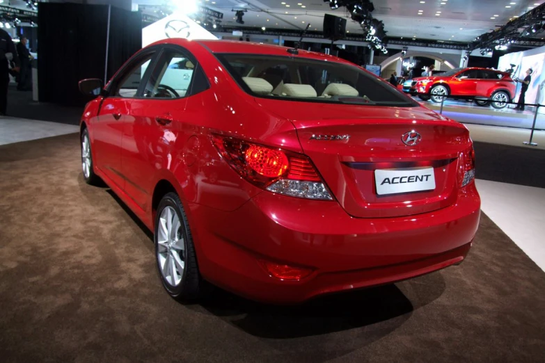 a red toyota car on display at an automobile show