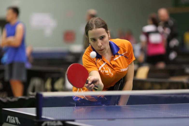 a  hitting a ball with a ping pong racket