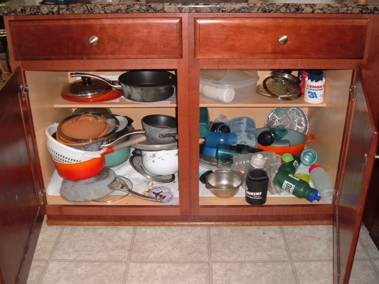 the wooden cabinet has many items in it