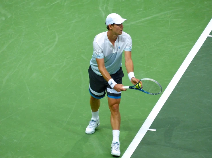 a man on a tennis court with a racquet